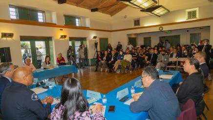 A room of people sitting at tables at the Anti-Asian Hate Crime Rountable